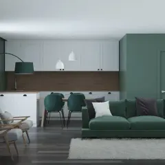 Nowoczesny salon z kuchnią, gdzie króluje **zielony kolor ścian**. Wygodna kanapa, fotele i krzesła tworzą przytulną przestrzeń.